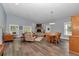 Spacious living and dining area with fireplace, wood floors, and ample natural light at 12080 Se Sunset Harbor Rd, Weirsdale, FL 32195