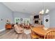 Spacious living and dining area with fireplace, wood floors, and ample natural light at 12080 Se Sunset Harbor Rd, Weirsdale, FL 32195