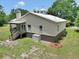 Aerial view of the back of a home showing the porch and outdoor features at 12080 Se Sunset Harbor Rd, Weirsdale, FL 32195