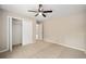 Bright bedroom featuring neutral colors, carpet, a ceiling fan, and closet at 12505 Sw 73Rd St, Ocala, FL 34481