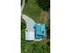 Aerial view of the property showcasing the house, detached garage, driveway, and surrounding landscape at 12690 Ne Highway 315, Fort Mc Coy, FL 32134