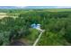 Aerial view showcasing the property surrounded by lush greenery at 12690 Ne Highway 315, Fort Mc Coy, FL 32134