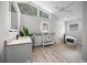 Bright bathroom with dual sinks, granite countertop, and modern tub under large window at 12690 Ne Highway 315, Fort Mc Coy, FL 32134