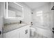 Modern bathroom with white tile, granite countertop, a white vanity, and a shower over tub at 12690 Ne Highway 315, Fort Mc Coy, FL 32134