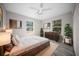 Bedroom with wood-look floors, ceiling fan, area rug, and natural light at 12690 Ne Highway 315, Fort Mc Coy, FL 32134