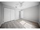 This bedroom offers gray wood flooring, a ceiling fan, and a closet for easy storage at 12690 Ne Highway 315, Fort Mc Coy, FL 32134