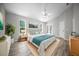Bedroom with wood-look floors, ceiling fan, and patio access at 12690 Ne Highway 315, Fort Mc Coy, FL 32134