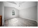 Vaulted ceiling bedroom featuring wood-look floors and a large arched window at 12690 Ne Highway 315, Fort Mc Coy, FL 32134