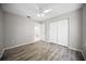Bedroom featuring wood-look flooring, a ceiling fan, and a spacious closet at 12690 Ne Highway 315, Fort Mc Coy, FL 32134