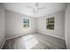 Sunny bedroom with two windows providing an abundance of natural light and wood floors at 12690 Ne Highway 315, Fort Mc Coy, FL 32134