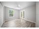 Bright bedroom with wood floors, white trim, a ceiling fan, and a glass door at 12690 Ne Highway 315, Fort Mc Coy, FL 32134