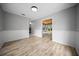 Dining room featuring wood floors, wainscoting, and an open doorway to the sunroom at 12690 Ne Highway 315, Fort Mc Coy, FL 32134