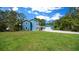 Charming home with well-maintained lawn and long driveway leading to a detached garage at 12690 Ne Highway 315, Fort Mc Coy, FL 32134