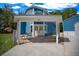 Covered front porch featuring double doors, welcome sign, chairs, and view of the long driveway at 12690 Ne Highway 315, Fort Mc Coy, FL 32134