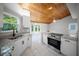 Well-lit kitchen showcasing white cabinets, granite countertops, a stainless steel oven, and a wood ceiling at 12690 Ne Highway 315, Fort Mc Coy, FL 32134