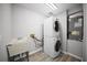 Laundry room equipped with a stacked washer and dryer set, sink, and storage space at 12690 Ne Highway 315, Fort Mc Coy, FL 32134