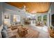 Open living area featuring wood flooring, breakfast bar and an adjoining kitchen at 12690 Ne Highway 315, Fort Mc Coy, FL 32134