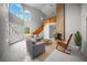 Bright living room with high ceilings, brick fireplace, and a wooden staircase at 12690 Ne Highway 315, Fort Mc Coy, FL 32134