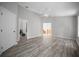 Spacious living area with sleek wood floors, ceiling fan, and easy access to the rest of the home at 12690 Ne Highway 315, Fort Mc Coy, FL 32134