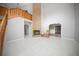 Open living room features a brick fireplace, wood staircase, and white tile flooring at 12690 Ne Highway 315, Fort Mc Coy, FL 32134