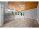 Open-concept living space with hardwood floors, wood ceiling, and a view of the breakfast bar at 12690 Ne Highway 315, Fort Mc Coy, FL 32134