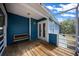 Inviting covered porch with a wooden bench and view of the property at 12690 Ne Highway 315, Fort Mc Coy, FL 32134