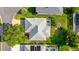 An overhead shot of a property boasting a screened-in lanai, set amidst well-manicured landscaping at 1308 La Estrellita Way, The Villages, FL 32162