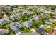 An aerial view of a well-landscaped home, surrounded by lush greenery and other houses at 1308 La Estrellita Way, The Villages, FL 32162