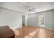 Well lit bedroom features neutral colored walls, ceiling fan and closet for ample storage at 1308 La Estrellita Way, The Villages, FL 32162