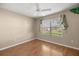 Bright bedroom features wood floors, ceiling fan and large window at 1308 La Estrellita Way, The Villages, FL 32162