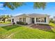 Attractive single-story home with a well-kept lawn and landscaping, bathed in sunlight at 1308 La Estrellita Way, The Villages, FL 32162
