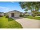 A well-maintained single-Gathering home featuring a garage and manicured front lawn under a clear sky at 1308 La Estrellita Way, The Villages, FL 32162