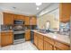 Modern kitchen with stainless steel appliances and backsplash at 1308 La Estrellita Way, The Villages, FL 32162