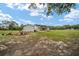 Spacious backyard featuring an outdoor firepit, detached building, and covered patio at 13663 Sw 66Th St, Ocala, FL 34481