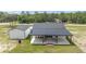 Backyard view of this home featuring a large patio and a detached garage at 13663 Sw 66Th St, Ocala, FL 34481