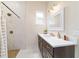 Modern bathroom featuring a double vanity, sleek fixtures, and a spacious walk-in shower with elegant tiling at 13663 Sw 66Th St, Ocala, FL 34481