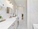 Bathroom featuring marble countertops, double sinks, gold fixtures, white cabinetry, and a soaking tub at 13663 Sw 66Th St, Ocala, FL 34481