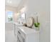 Bright bathroom featuring marble floors, double vanity, makeup table, and gold fixtures at 13663 Sw 66Th St, Ocala, FL 34481