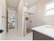 Bright bathroom featuring marble shower, dark cabinets, single sink, and designer fixtures at 13663 Sw 66Th St, Ocala, FL 34481