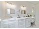 Bathroom with marble countertops, double sinks, gold fixtures, white cabinetry, and a makeup vanity at 13663 Sw 66Th St, Ocala, FL 34481