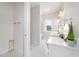 Bright bathroom featuring marble floors, double vanity, makeup table, and a separate room with a soaking tub at 13663 Sw 66Th St, Ocala, FL 34481