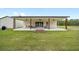 Expansive covered patio with ceiling fans offers an ideal outdoor living space at 13663 Sw 66Th St, Ocala, FL 34481