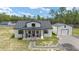 Beautiful home with inviting front porch, rocking chairs, and detached garage at 13663 Sw 66Th St, Ocala, FL 34481