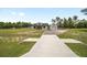 Exterior view of the home with a large driveway leading to a detached garage at 13663 Sw 66Th St, Ocala, FL 34481