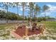 Backyard fire pit area surrounded by seating, perfect for entertaining and relaxing at 13663 Sw 66Th St, Ocala, FL 34481