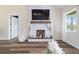 Modern fireplace with stone surround, wooden mantel, and decorative accents at 13663 Sw 66Th St, Ocala, FL 34481