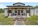 Inviting front porch with rocking chairs and decorative details welcomes you home at 13663 Sw 66Th St, Ocala, FL 34481