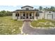 Charming front porch featuring ceiling fans, rocking chairs, and stylish entry door at 13663 Sw 66Th St, Ocala, FL 34481
