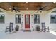 Close up of a lovely front porch with a red door and welcoming decor at 13663 Sw 66Th St, Ocala, FL 34481
