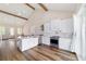 Open kitchen features island, stainless steel appliances, farmhouse sink, and wood floors at 13663 Sw 66Th St, Ocala, FL 34481